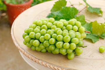 Fresh Green Grapes with Leaves on Wooden Board - Healthy Organic Fruit for Summer