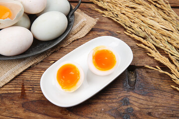 Fresh Free-Range Eggs with Golden Yolks and Wheat on Rustic Wood Table - Organic Farm Breakfast Ingredients