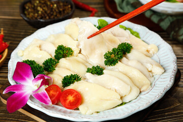 Fresh Sliced Chicken Breast Platter with Garnish and Chopsticks on Wooden Table