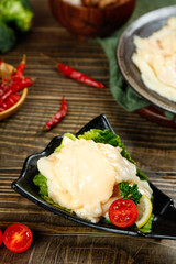 Raw chicken breast with fresh vegetables and spices on rustic wooden table