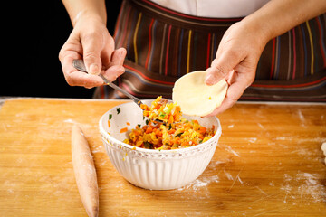 Making Fresh Dumplings - Chef Filling Wrapper with Aromatic Vegetable Mixture on Floured Kitchen Surface