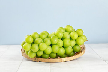 Fresh Green Grapes in Wicker Basket on White Wooden Table - Healthy Fruit Photography