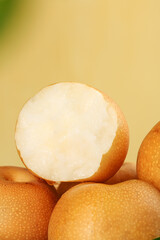 Fresh Asian Pears Cut Open Showing White Flesh on Golden Background