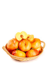 Fresh Garden Peaches in Wicker Basket with Chopped Peach Slices Showing Sweet Pulp