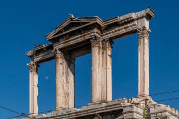 The ancient Arch of Hadrian, Athens, Greece, with the moon in the background
