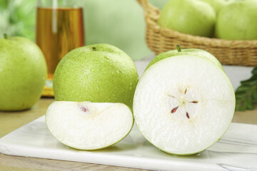 Fresh Green Pears Showcase with Crown Seeds and White Flesh on Display Plate