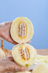 Fresh Honeydew Melon Cut in Half Showing Seeds and Sweet Flesh on Wood Surface