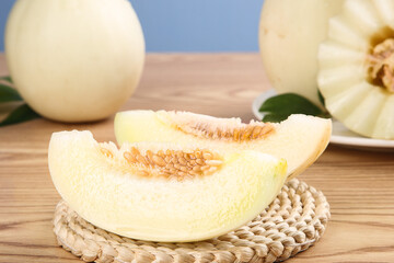 Fresh Honeydew Melon Slices Display on Wooden Table with Whole Melons