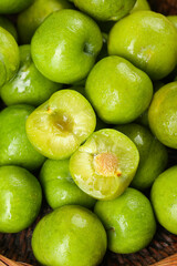 Fresh Green Plums with Yellow Flesh Cut Open Display Showing Natural Fruit Texture