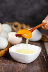 Fresh Farm Eggs with Golden Yolk Separation on Rustic Wooden Background