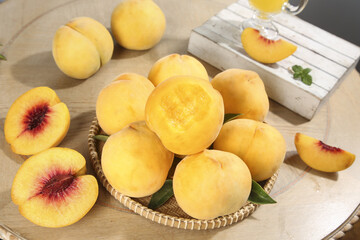 Fresh Yellow Peaches in Wicker Basket on Wooden Table - Organic Summer Fruit Display