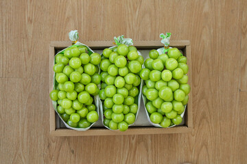 Fresh Green Grapes in Paper Bags Wooden Box Package on Wood Background
