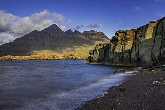 Sea, surf, beach, shore, cliff, mountains, clouds, morning light, long exposure, summer, Berufj&ouml;rdur, Blabj&ouml;rg cliffs, Teigarhorn behind, East Fjords, Iceland