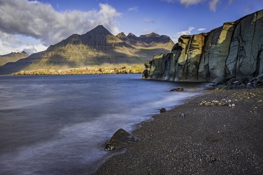 Sea, surf, beach, shore, cliff, mountains, clouds, morning light, long exposure, summer, Berufj&ouml;rdur, Blabj&ouml;rg cliffs, Teigarhorn behind, East Fjords, Iceland