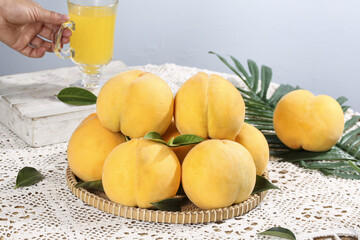 Fresh Golden Yellow Peaches with Juice on Rustic Table Setting