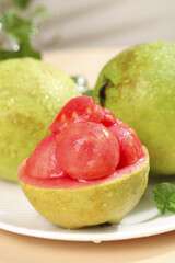 Fresh Tree-Ripened Cream Guavas from Guangxi China Harvest with Pink Flesh on White Plate