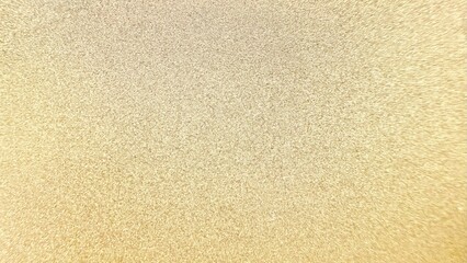 golden glitter shimmer texture with radiant sparkling particles creating luminous abstract background ideal for wallpaper or banner design