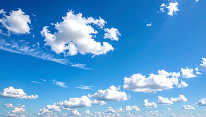 A vast expanse of a clear blue sky dotted with fluffy white clouds