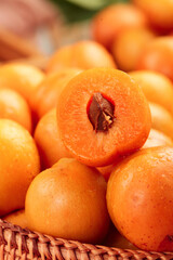 Fresh Ripe Apricots in Basket with Cut Half Showing Pit and Orange Flesh