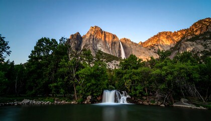 Majestic waterfall cascading into a tranquil lake, surrounded by towering mountains and lush greenery at dawn