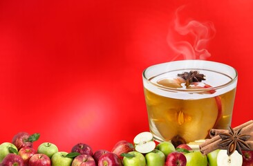 Hot drink apple cider with apples, cinnamon and red banner,spices