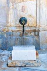 Decorative faucet of the well where people wash their feet before entering the Al Jazzar Mosque in Acre, Akko's old city on a sunny day.
