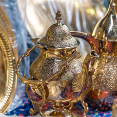 Brass tea pots on a table in the market of Old Acre, Akko Israel.

