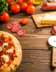 Pizza ingredients on a rustic wooden table