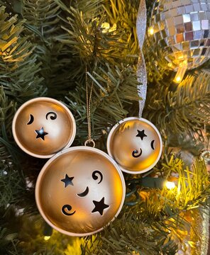 Closeup of gold christmas decoration on a lit Christmas Tree