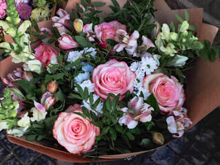 Bouquet of pink roses, white chrysanthemums, and snapdragon flowers creating a stunning floral arrangement