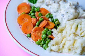 Cod Fillet Fish With Mashed Potatoes Carrots And Peas In A Pasley Sauce