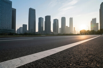 Wide asphalt roads and modern city buildings under a sunset sky