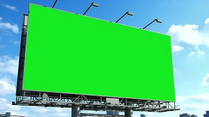 Outdoor billboard with green screen for advertising mockup. Blank display against blue sky and city background.