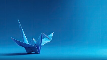 A vibrant origami crane against a deep blue backdrop