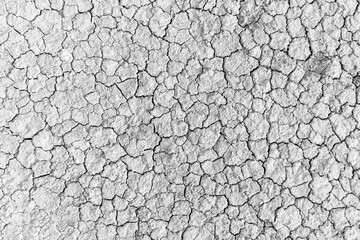 Close-up of dry, cracked soil surface,Close-up image showcasing the intricate patterns of a dry, cracked sand surface, highlighting the natural abstract formations and textures.