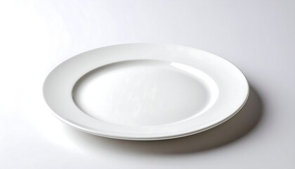 A single, clean, white dinner plate sits on a white surface.  Soft light casts subtle shadows