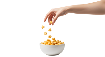 Serving star-shaped cereal into a white bowl against a black backdrop