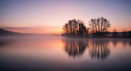 Fototapeta premium Serene Sunrise Over Misty Lake.