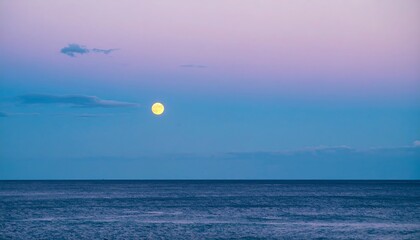 Full moon over tranquil ocean