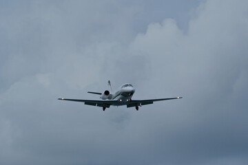 Airplane in the cloudy sky. Private plane in flight, Business jet in the sky.