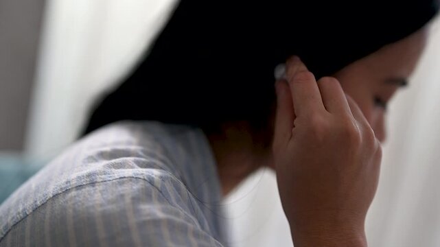 Young women enjoy listening to music on earphones or radio, streaming indoors for relaxation, wellness, mental health, and a happy lifestyle.