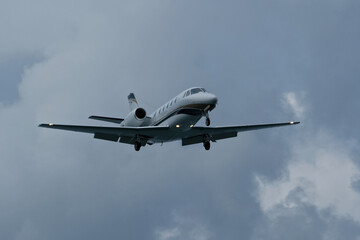 Airplane in the cloudy sky. Private plane in flight, Business jet in the sky.