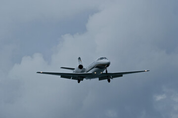 Airplane in the cloudy sky. Private plane in flight, Business jet in the sky.
