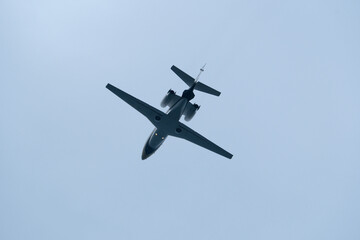 Airplane in the cloudy sky. Private plane in flight, Business jet in the sky.