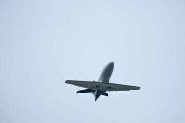 Airplane in the cloudy sky. Private plane in flight, Business jet in the sky.