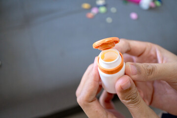 Unveiling Health Close-Up of Medication Preparation and Pill Bottle Readiness in Hand for Well-being