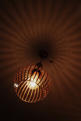 The ceiling light is on and shining.