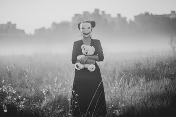 Spooky Halloween scene with mask, teddy bear, and knife