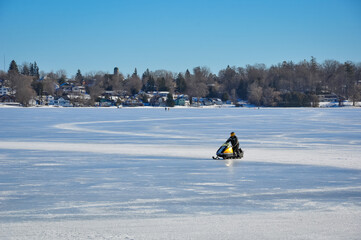 Snowmobile in frozen lake during winter