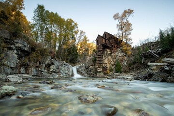 Crystal Mill by a flowing river in autumn, Colorado.